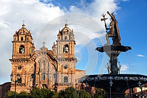 Fountain and catholic church Cusco or Cuzco town Peru