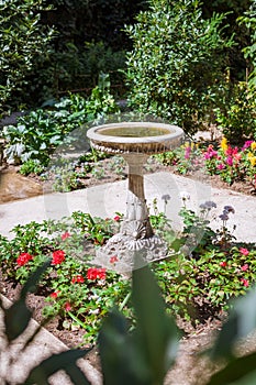 Fountain of a classic flower garden of a Parisian course in Paris