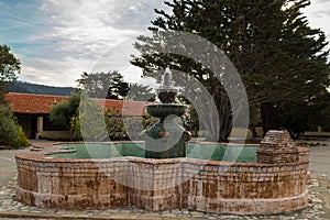 Fountain in courtyard, The Carmel Mission Basilica, the mission of San Carlos Borromeo, founded in 1770 by Junipero Serra, Carmel-