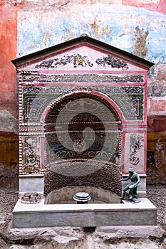Fountain decorated with mosaics in the ancient roman city of Pompeii, Italy