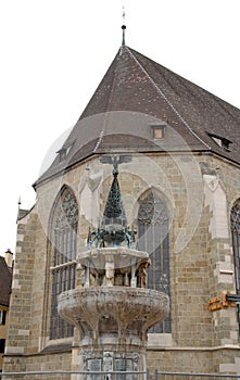 Fountain with eagle and two stained glass windows of the cathedral town of Nordlingen in Germany