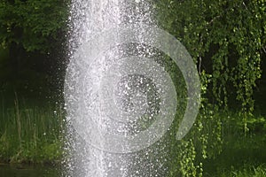 Fountain with flowing water in a summer park