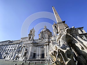 The fountain of the four rivers with the facade of the church of Santa Agnese in Piazza Navona in Rome