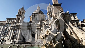 The fountain of the four rivers with the facade of the church of Santa Agnese in Piazza Navona in Rome