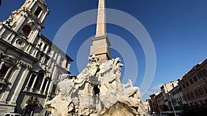 The fountain of the four rivers with the facade of the church of Santa Agnese in Piazza Navona in Rome