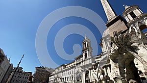 The fountain of the four rivers with the facade of the church of Santa Agnese in Piazza Navona in Rome