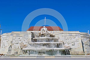 a fountain in front of a castle in summer