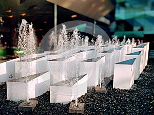 The fountain in front of the modern building.