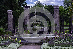 Fountain In front Of Pillars With Gate