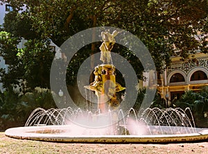 Fountain at Gabriel Miro plaza in Spanish city of Alicante at Costa Blanca surrounded by green palm trees historical landmarks photo