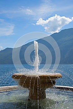 Fountain with garda lake background