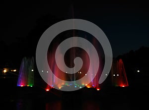 Fountain in garden colorful water lighting night scene