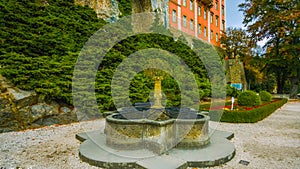 A fountain in the garden in Poland - north of the country - a castle in the middle of the forest - overlooking the trees and beaut