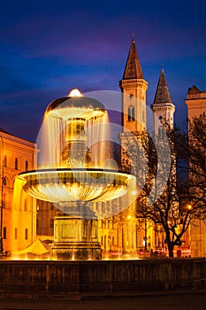 Fountain in the Geschwister-Scholl-Platz and St. Ludwig`s Church