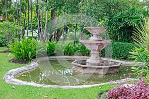 Fountain in green garden, Thailand