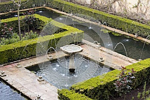 Fountain in green generalife garden park in alhambra photo