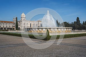 Fountain at Jardim da Praca do Imperio Square with Jeronimos Monastery - Lisbon, Portugal photo