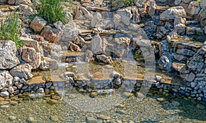 Fountain made of stones. Natural waterfall