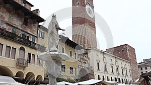 Fountain of Madonna Verona and the  Lamberti Tower in Piazza delle Erbe in Verona