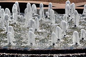A fountain with many sprinklers in a park