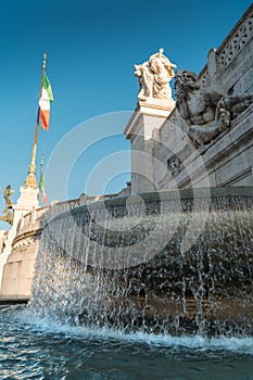 Fountain at National Monument to Victor Emmanuel II in Rome, Italy with Italian flag