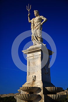 Fountain Neptune against the background of the evening blue sky. Havana, Cuba