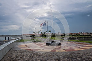 Fountain in Panama City with country flag and Casco Viejo Old City on background - Panama City, Panama