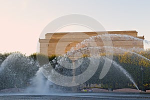 Fountain in the park in front of National Archives Building before sunset in Washington DC, USA.