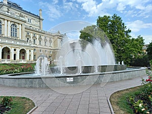 Fountain in the park tree grass roses flowers building architechture park town city center ukraine odessa beauty water sky blue