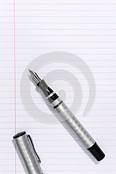 Fountain pen on blank lined paper background