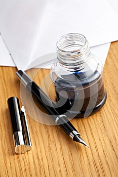 Fountain pen and inkwell on desk