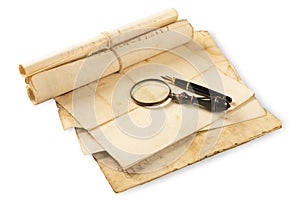 Fountain pen and magnifying glass with old sheets