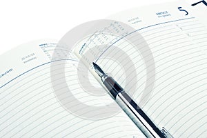 Fountain pen on opened diary