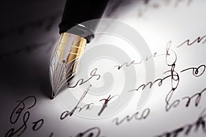 Fountain pen on top of a letter written in cursive