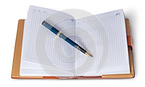 Fountain pen on top of the open notebook