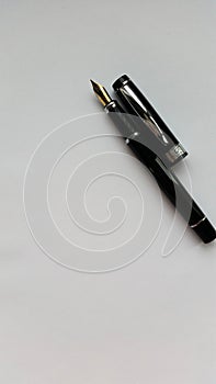 Fountain pen on a white paper. Isolated on white background