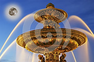 Fountain at the Place de la Concorde in Paris by night (with the moon), France
