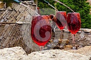 Fountain with red wine pouring from bottles