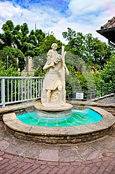 Fountain is a religious statue of a man with a child on his shoulders in Germany