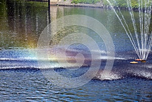 Fountain on the river. Rainbow around the jets. Riga, Latvia