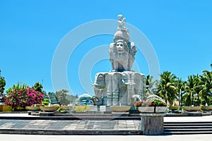 Fountain in shape of lions with elephants of stone with flowers in the park