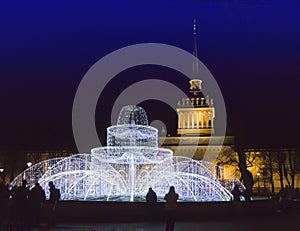 Fountain from the shining fires on the square in front of the Admiralty on New Year`s Eve. St. Petersburg. Russia