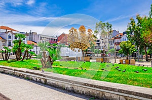 Fountain in small park and typical colorful buildings houses on Praca Conde Agrolongo square in Braga city