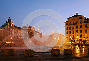 Fountain on square in evening. Munich