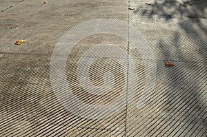 Fountain in the square lined with a mosaic of tiles. through a science terrace or bridge made of metal stainless steel slats. the