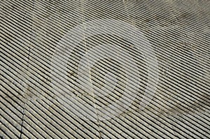 Fountain in the square lined with a mosaic of tiles. through a science terrace or bridge made of metal stainless steel slats. the