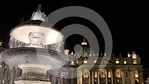 Fountain of St. Peter`s Square at night in Vatican City