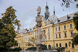 Fountain with a statue of St. Josefa at Charles Square near the renaissance building of Municipal Court and New Town Hall in the photo