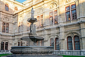 A fountain with Statues in front of the Opera in Vienna, Austria