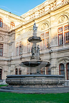 A fountain with Statues in front of the Opera in Vienna, Austria